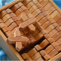 Wooden building blocks in a wooden tray on a blue background