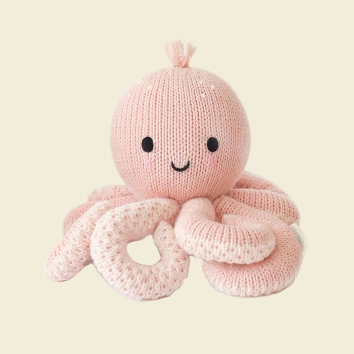 Knitted pink octopus toy with a smiling face