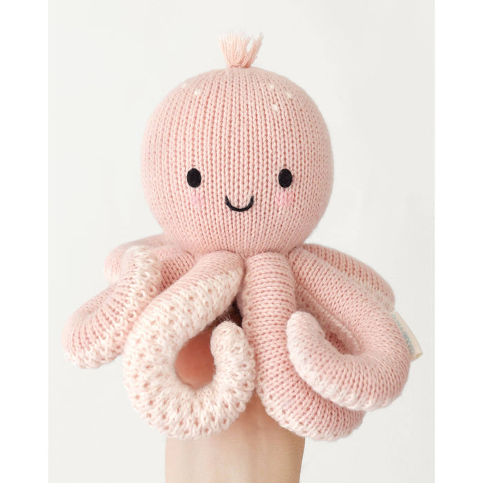 Knitted pink octopus toy with a smiling face