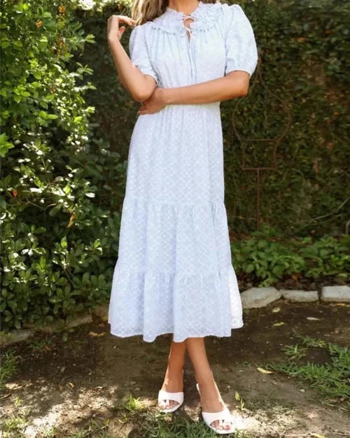 Light blue burnout chiffon midi dress with puff sleeves styled outdoors