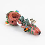 a spoon with owls and nature figurines facing away