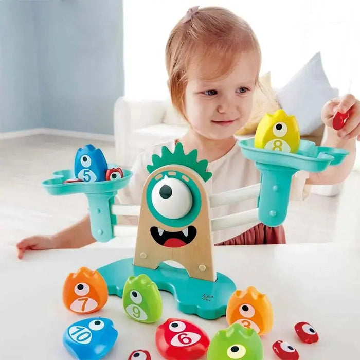 Child playing with a colorful educational toy featuring numbers and shapes