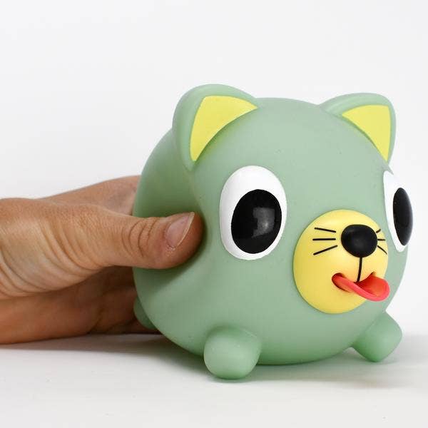 Green cat-shaped toy with a hand interacting with it on a white background