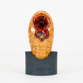 Beehive Macusi glass pipe with small bee figurine in honey on a white background