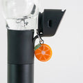 Orange glass Puffco charm with a bright citrus-inspired design