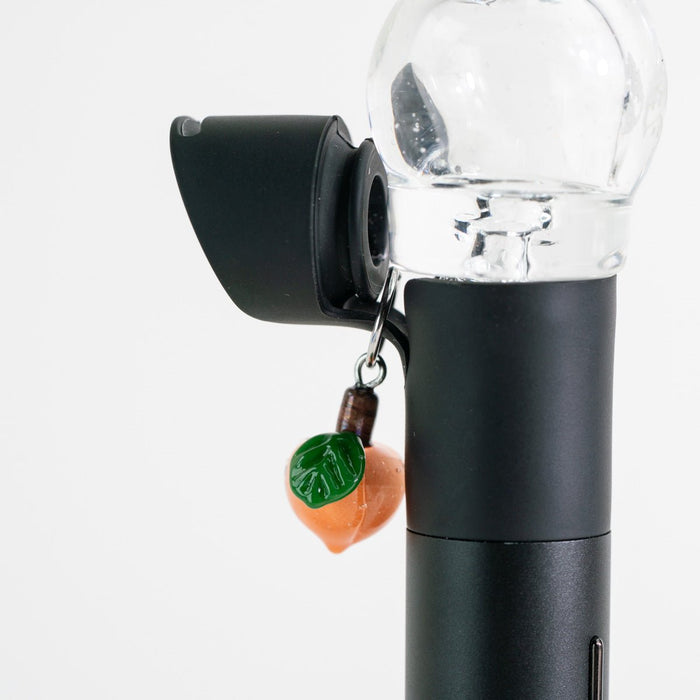 Fruit-themed glass Puffco charm with a sweet peach design on a Pivot device