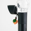 Fruit-themed glass Puffco charm with a sweet peach design on a Pivot device
