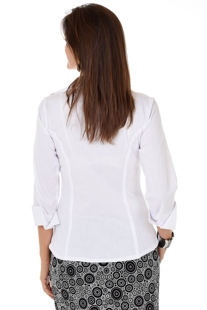 Woman wearing a white blouse with a patterned skirt on a white background