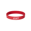 Red wristband with 'USATF' text on a white background
