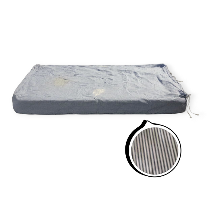 Gray mattress cover with a close-up of the texture on a white background
