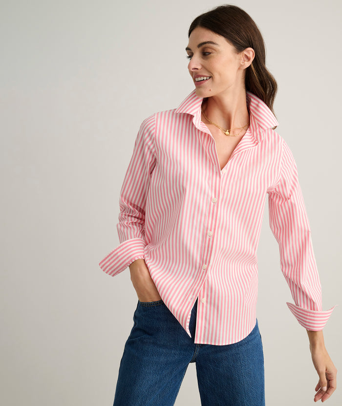 Model is wearing UNTUCKit Isabella shirt in pink and white stripe.