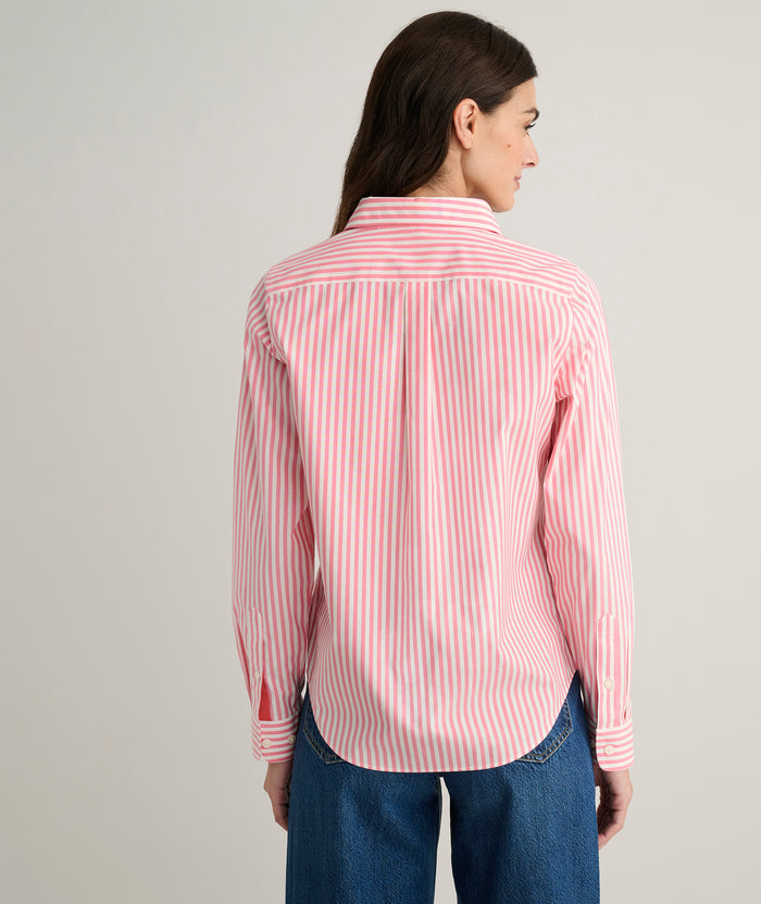 Model is wearing UNTUCKit Isabella shirt in pink and white stripe.
